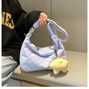 Detail of lavender waffle texture shoulder bag with cute yellow star plush charm