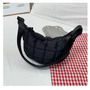 Detail of black quilted cloud bag showing puffed nylon texture and half-moon structure