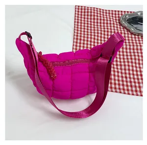 Detail view of the quilted magenta dumpling bag featuring a puff crescent moon shape