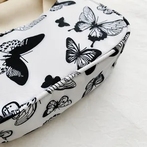 Macro view of butterfly print on textured fabric with detailed edge stitching for bags