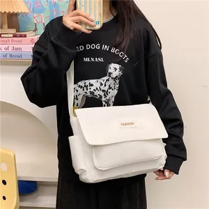Borsa messenger in tela bianca con tracolla regolabile e toppa fashion per uso quotidiano