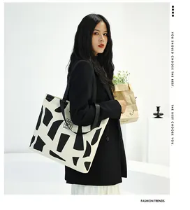 Close-up of high-capacity canvas tote bag with black and white geometric patterns