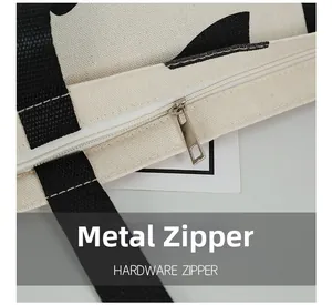Close-up of the durable hardware zipper and nylon handle on the canvas tote bag