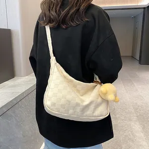 Off-white waffle weave tote bag with shoulder strap and yellow bear charm detail