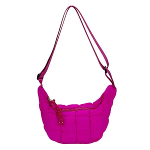 Hot pink quilted crescent crossbody bag with cloud pleats and adjustable strap