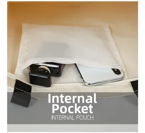 Detail view of the canvas tote internal mesh pouch with a phone and perfume bottle
