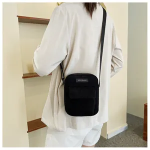 Minimalist black corduroy crossbody square bag for women with fashion label and shoulder strap