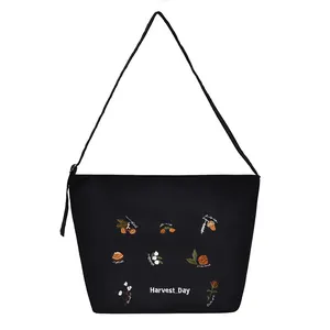 Black corduroy shoulder bag featuring harvest floral embroidery and Harvest Day text