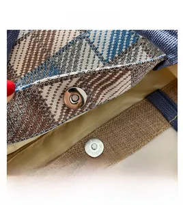 Detail view of woven tote bag with magnetic closure and blue textured fabric strap