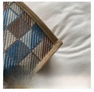 Detail showing the braided jute texture and diamond pattern binding on canvas tote bag