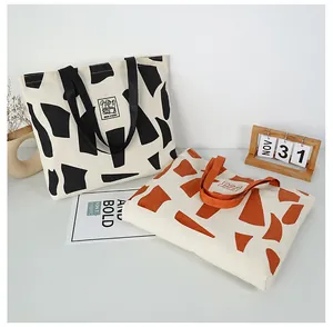 Close-up of durable canvas tote bags with geometric patterns and reinforced handles