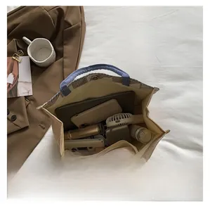 Top view of spacious canvas tote bag with laptop and daily essentials in compartments