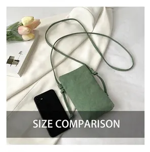 Minimalist green canvas phone bag shown next to a smartphone for size comparison