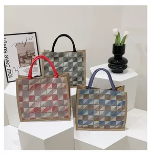 Detailed display of three checkered canvas tote bags with thick woven carry handles