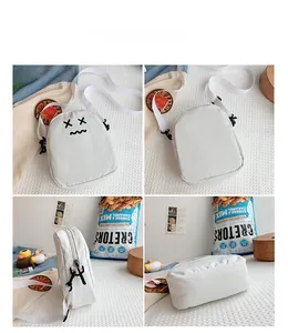 Detailed views of a white cartoon crossbody bag with embroidered face and nylon strap