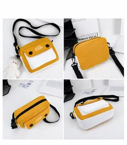 Detail view of yellow and white canvas crossbody bag with kòq logo and adjustable strap