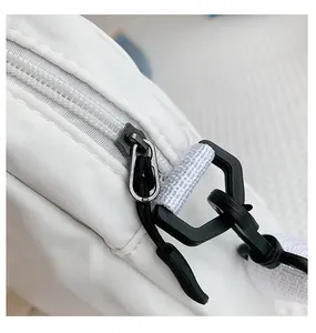 Detail of smooth white nylon fabric with high-quality zipper and black plastic buckles