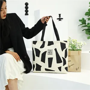Large canvas tote bag with abstract black geometric prints for student commute and work use