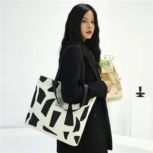 Large canvas tote bag with black and white abstract geometric prints and zipper closure