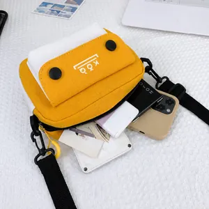 Internal capacity of canvas crossbody bag showing phone, power bank and cards