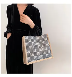 Detailed close-up of textured checkered canvas tote bag with woven jute side panels