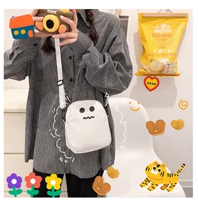 Detailed view of mini white cartoon ghost crossbody bag with adjustable fabric strap