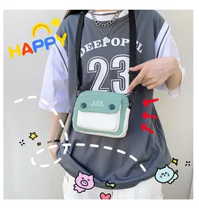 Close-up of small green and white canvas crossbody bag with dual buttons and KÖQ logo
