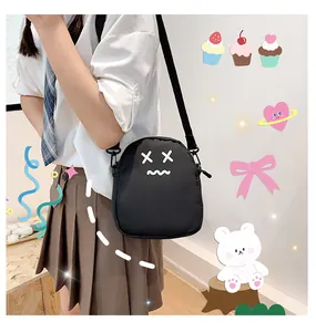 Close-up of cute cartoon crossbody bag with adjustable nylon strap worn by a model