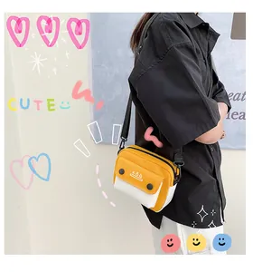Close-up of yellow and white canvas crossbody bag with adjustable black strap on model