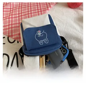 Internal capacity of blue and white canvas bag with cute cartoon embroidery and items