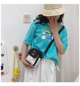 Close-up of a canvas crossbody bag featuring a cute cartoon rabbit embroidery detail