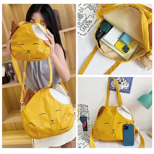 Detail view of yellow cat face canvas bag set showing interior capacity and embroidery