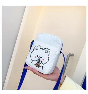 Primer plano del bolso de lona blanca con lindo oso de dibujos animados y correa azul