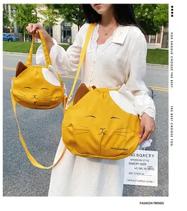 Detail of yellow cat canvas bag featuring cute animal embroidery and bicolor patchwork