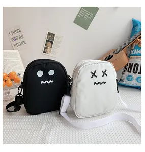 Detail view of mini cartoon crossbody bags in black and white with soft nylon texture