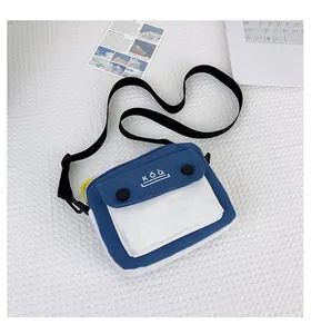 Detail of blue and white canvas crossbody bag with KŎQ logo and adjustable strap