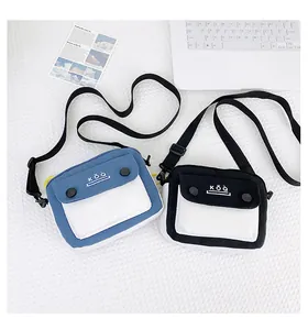 Detail of canvas crossbody mini bags in blue and black patchwork with adjustable straps