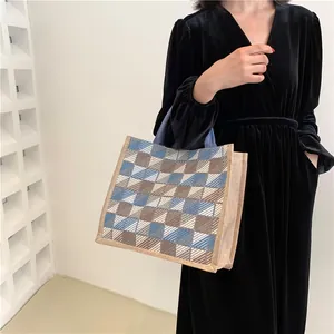 Checkered woven canvas tote bag in blue and brown for stylish daily commuting and campus use