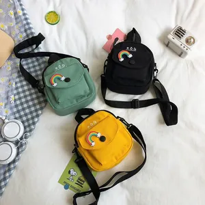 Cute canvas mini crossbody bags in green, black and yellow with rainbow patches