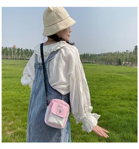 Close-up of pink and white canvas mini crossbody bag with cute rabbit cartoon print
