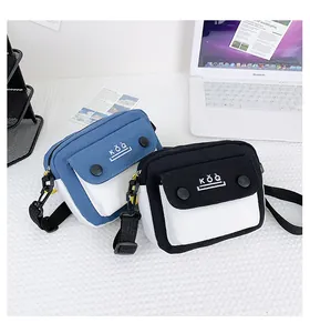 Detail of color-block canvas crossbody bags with magnetic snap closure and adjustable straps