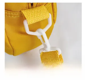 Detail view of durable white plastic swivel hooks and zipper on yellow canvas tote bag
