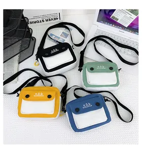Flat lay of small canvas crossbody bags in four colors with KOQ lettering on the flap