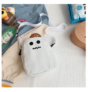 Detail of cute white ghost crossbody bag with adjustable strap and cartoon face design