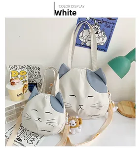 Detailed comparison of large cat-themed white canvas tote and small crossbody shoulder bag