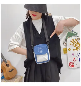 Detail of a mini canvas crossbody bag with blue contrast and cute bunny embroidery