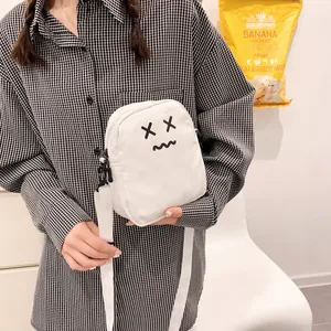 Cute white cartoon crossbody bag with adjustable strap and minimalist smiley face graphic