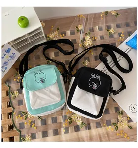 Detail of canvas crossbody bags with cute animal patterns and adjustable straps