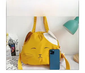 Close-up of yellow cat canvas bag with embroidery and adjustable strap for scale