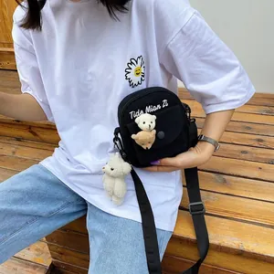 Korean style black canvas crossbody bag with cute plush charms and white embroidery